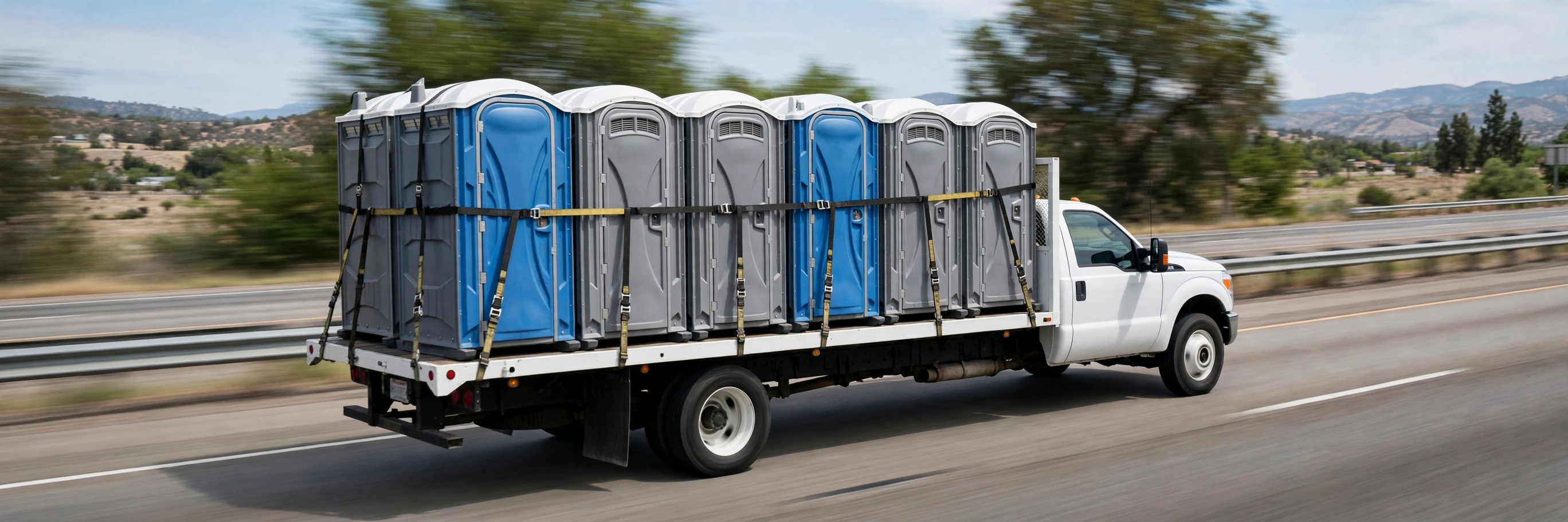 Service truck loaded with portable toilets heading out for same-day delivery